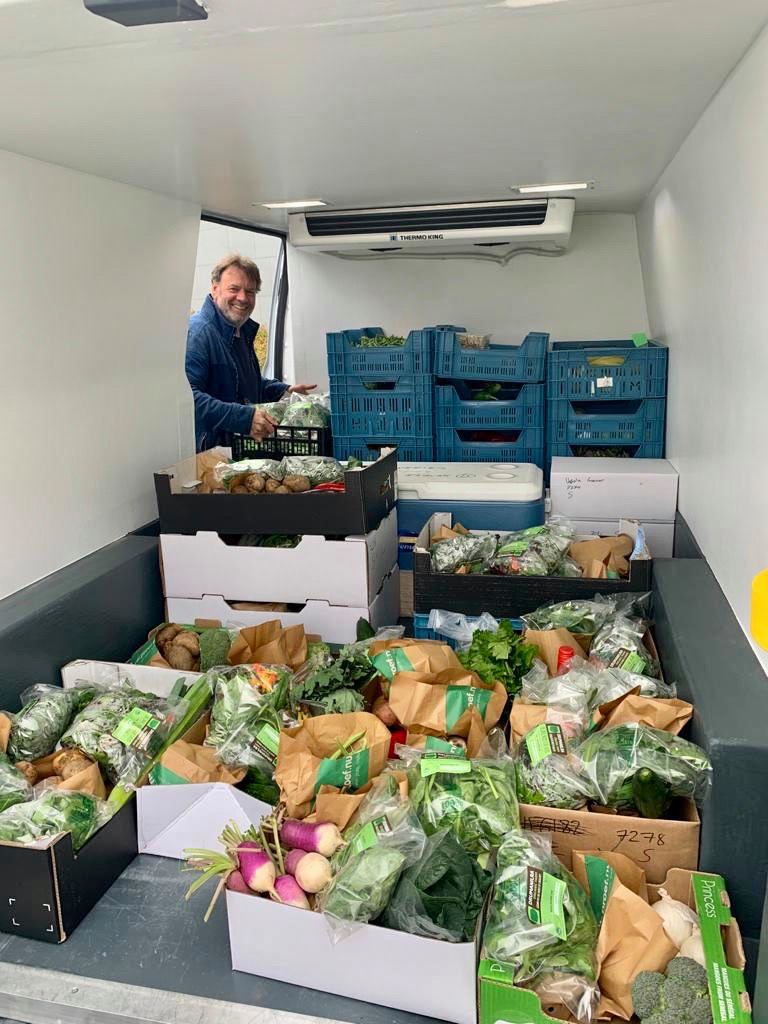 Liam Gavin with organic fruit and veg boxes ready for delivery in refridgerated van
